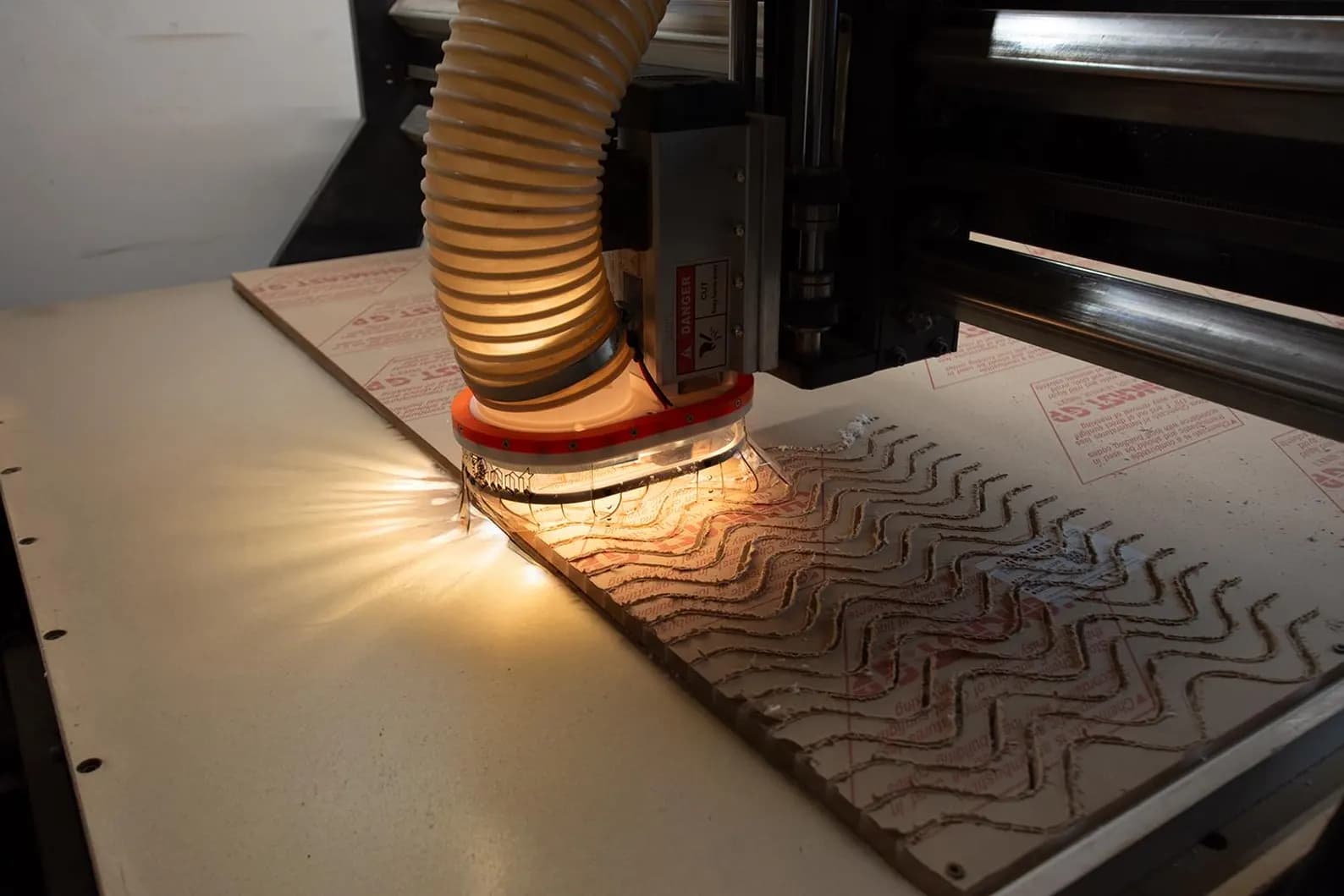 Dast Boot collecting chips during a CNC carve with the clear skirt and LED halo visible
