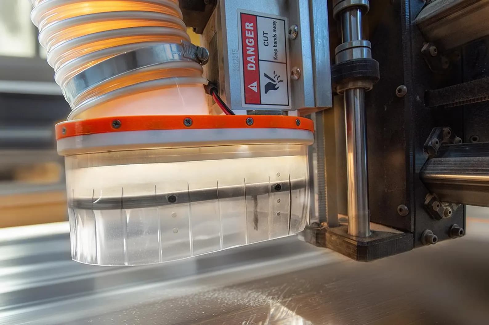 Installed Dast Boot with a supported extraction hose routed above the CNC spindle